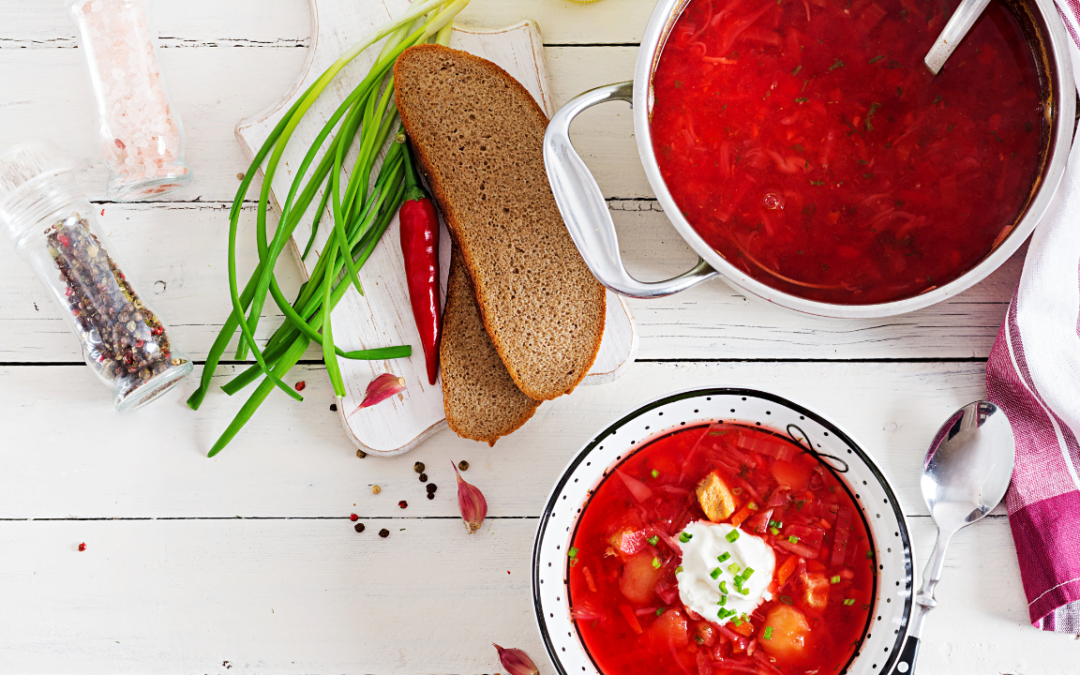 Borscht on a white table with brown bread